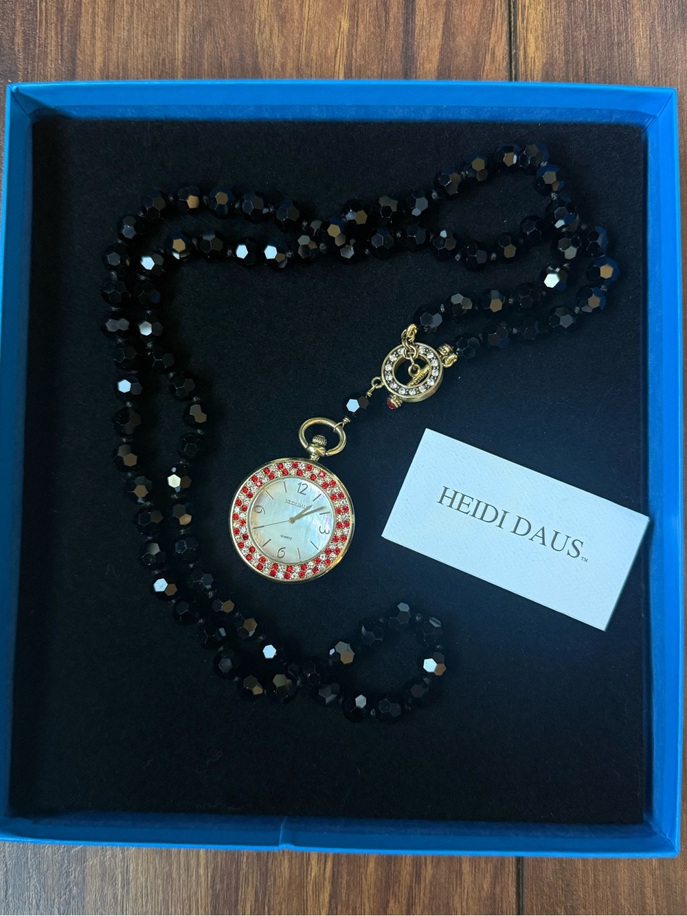 Heidi Daus Black Beaded Necklace with Gold Watch Pendant and Red Crystal Halo